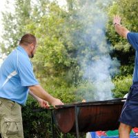 Two men lighting the braai fire